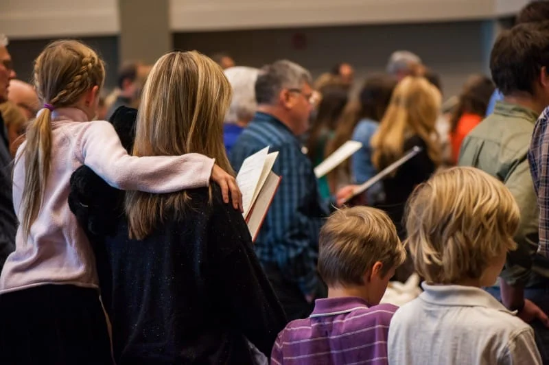 The congregation singing in the sanctuary