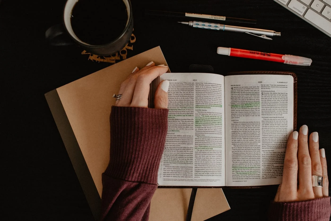 A woman studying an open Bible with notes