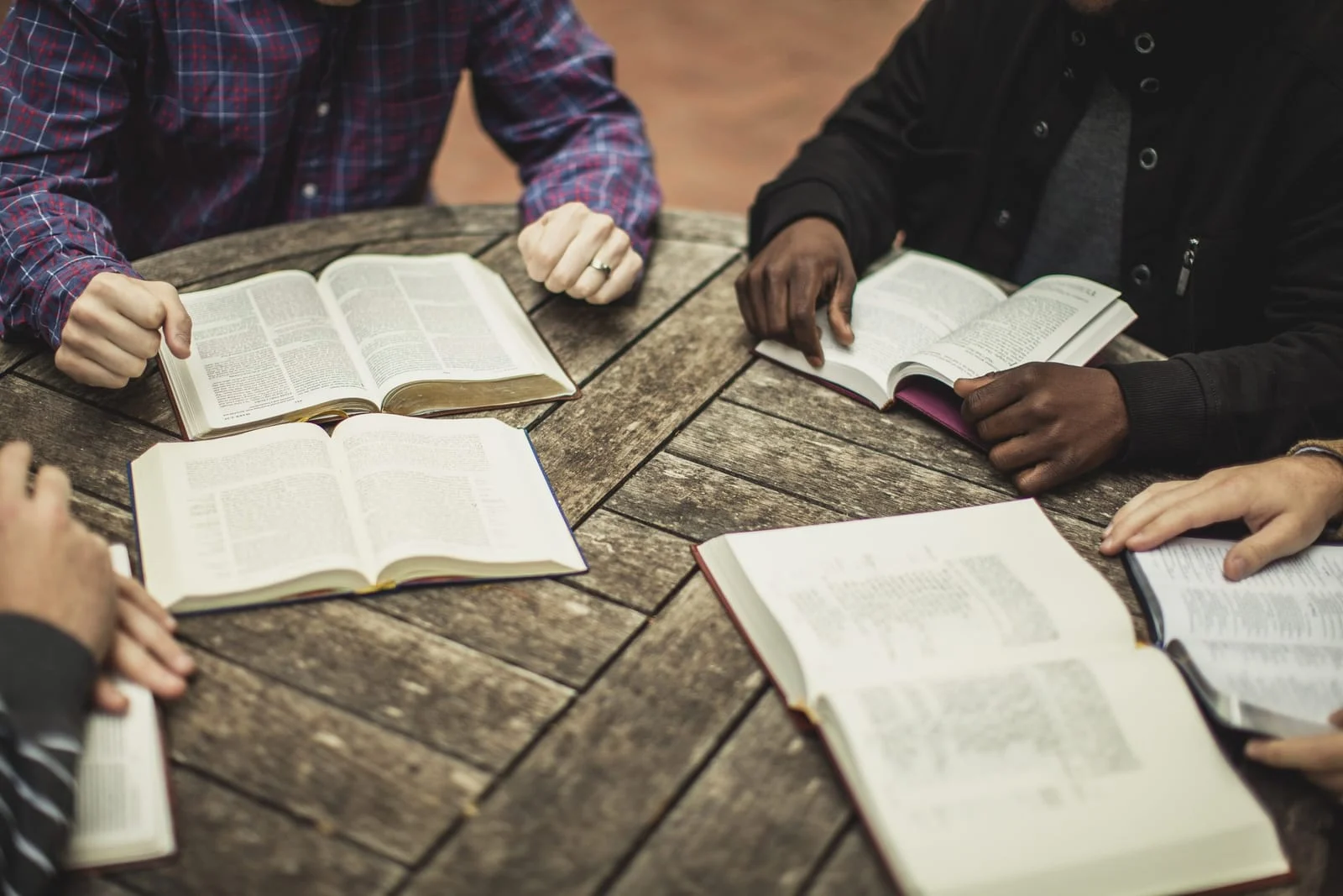 Open Bibles on a wooden table during a group study